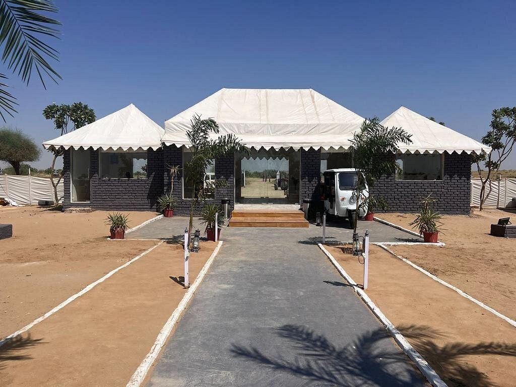 Deluxe Swiss Tents with attached tiled bathrooms and traditional decor.

Continued stay; evening jeep safari into the deep desert.