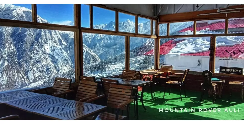 Description: A premier 4-star boutique resort located in the upper reaches of Auli, offering unobstructed views of the Nanda Devi and Dronagiri peaks. The resort features Himalayan-style architecture with wooden interiors and centrally heated rooms. It is known for its "ski-in, ski-out" accessibility and a warm, glass-walled dining area where guests can enjoy gourmet local and continental cuisine while watching the snowfall.