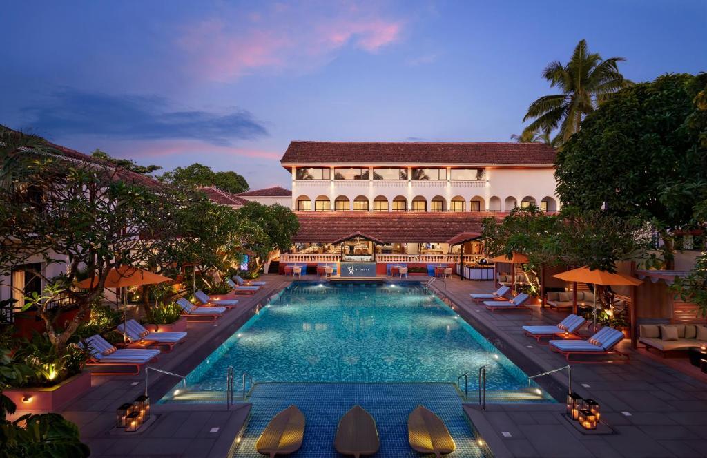 Description: An upscale 4-star boutique hotel that captures the vibrant spirit of Goa. Located in the heart of Baga, it features stylish rooms with balconies overlooking two shimmering outdoor pools. The resort is known for its energetic atmosphere, "soulful" service, and high-end dining, making it the perfect base for an adventure-themed trip.