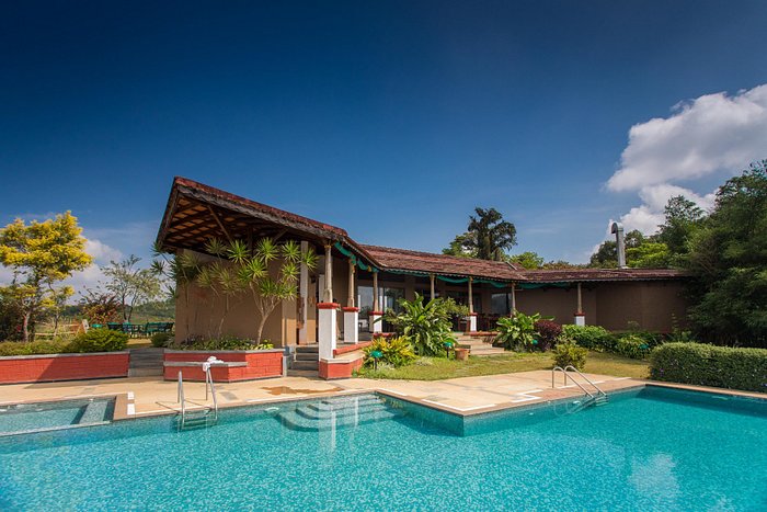 Description: 

A premier 4-star resort perched on a hill, offering stunning views of the misty valleys. It features individual cottages with large glass windows and private balconies. The property includes an infinity pool overlooking the mountains, a specialized Ayurvedic spa to help recover from the trek, and a restaurant serving authentic "Kodava" cuisine.
