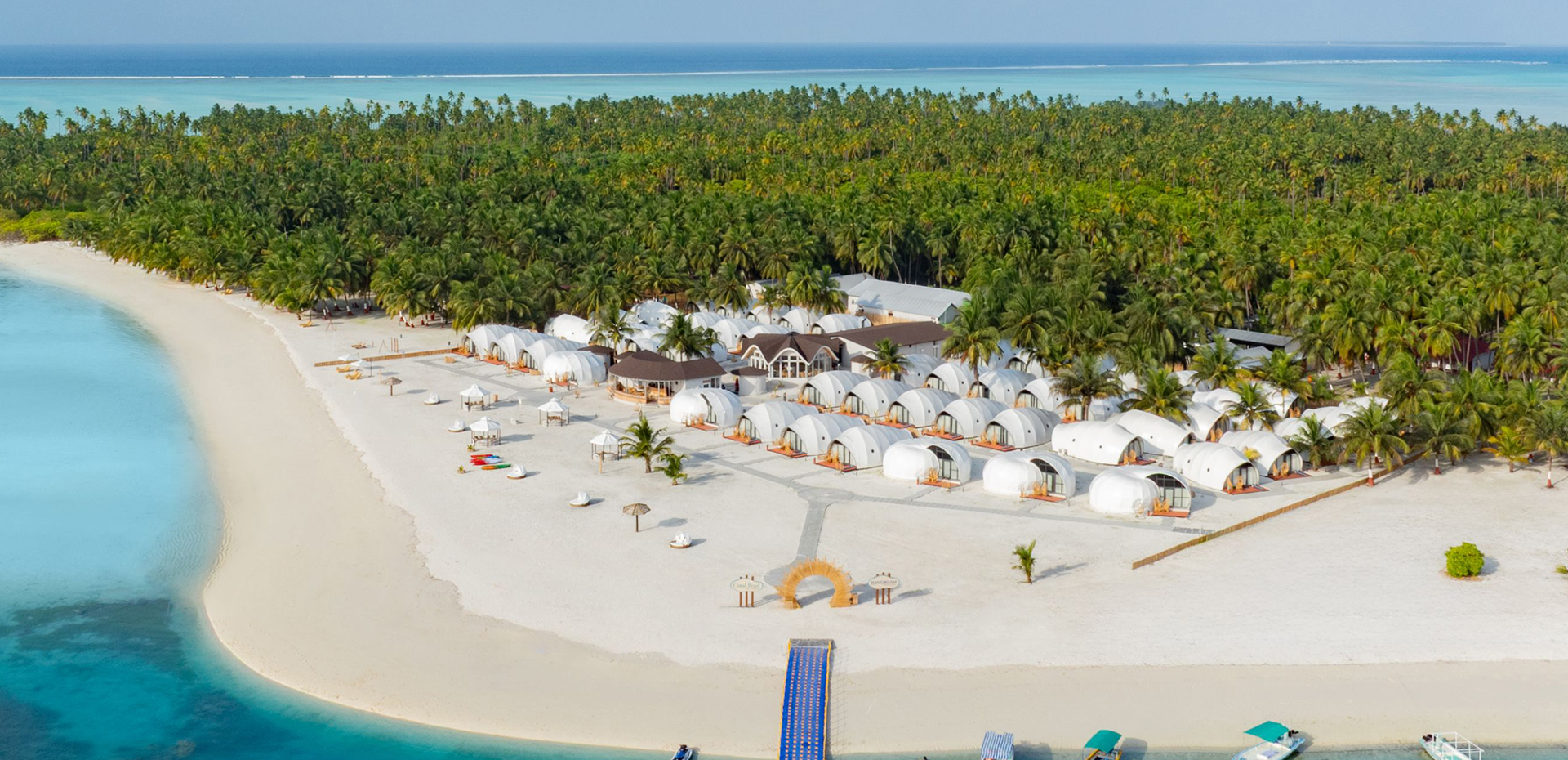 Description: This premium resort is the jewel of Lakshadweep’s honeymoon stays, situated on an uninhabited island surrounded by a vast turquoise lagoon. The independent AC wooden cottages are set right on the white sands, offering maximum privacy. The resort features a beachfront restaurant and a beach bar (the only one in the archipelago), providing a serene, "castaway" luxury vibe perfect for newlyweds.
