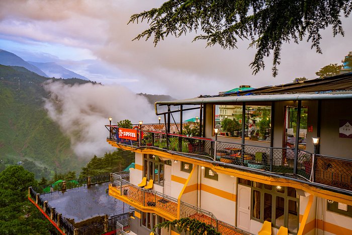 Description: A premier 3-star boutique hotel located in the quiet corners of McLeodGanj, offering a perfect base before your trek. The rooms feature private balconies with panoramic views of the Dhauladhar range and the Kangra Valley. The property is known for its serene ambiance, a rooftop terrace ideal for pre-trek briefings, and an organic kitchen that serves specialized high-protein meals for trekkers. Its proximity to the Bhagsu trekking trail ensures a seamless start to your adventure.