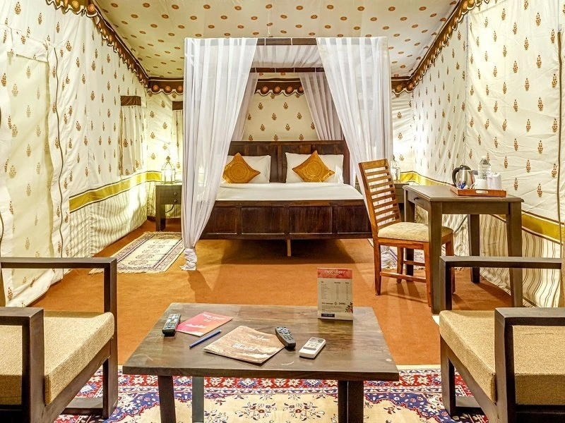 Description: This is the most prestigious accommodation within the Rann. The Premium AC Tents are designed to offer a 5-star glamping experience. Each tent features luxurious wooden flooring, plush upholstered furniture, a climate-controlled environment, and an en-suite bathroom with premium toiletries. The tent city provides a massive dining hall serving gourmet Kutchi and global cuisines, a high-end clubhouse, and a dedicated spa. It is located at the very edge of the White Rann, providing immediate access to the salt flats for sunset viewing.